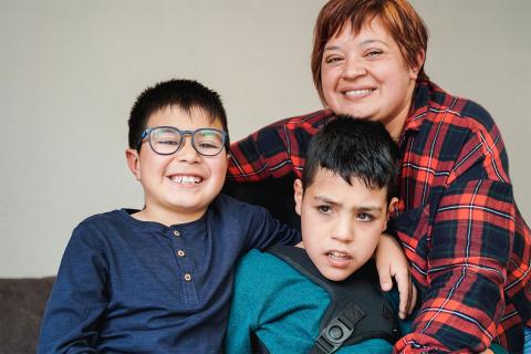 Smiling caregiver with two happy children